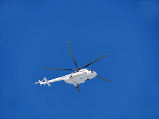 helicopter Mi-8MTV flies in the blue sky blurry motion