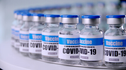 Glass vials for Covid-19 vaccine in laboratory. Group of Coronavirus vaccine bottles. Medicine in ampoules.