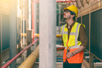 Portrait of an industrial engineer work for daily routine checking the equipment and structure working in outdoor at factory area