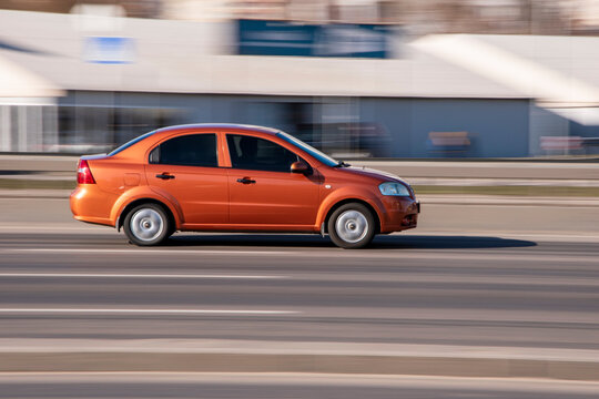 Ukraine, Kyiv - 3 March 2021: Orange Chevrolet Aveo car moving on the street;