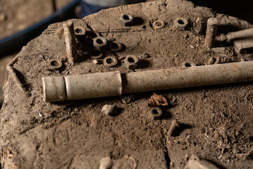 scrap metal parts and old rusty tools in abandoned workshop