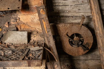 scrap metal parts and old rusty tools in abandoned workshop