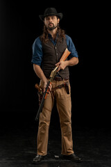 Cowboy with guns. Studio shooting