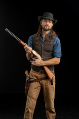 Cowboy with guns. Studio shooting
