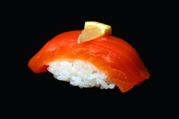 salmon sushi and a piece of a lemon on a black background healthy  food