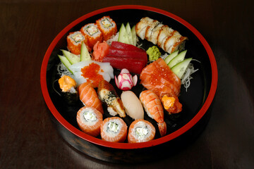 sushi a set in the round box against a dark background