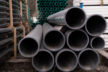 PVC pipes or tubes in different sizes for sewer or construction or industrial or manufacturing or water or engineering or equipment or material purposes create an abstract appearance 