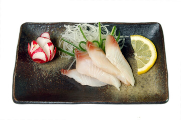 by sashimi from white fish on a plate it is isolated on a white background