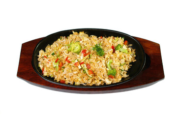rice with vegetables in a pig-iron frying pan it is isolated on a white background