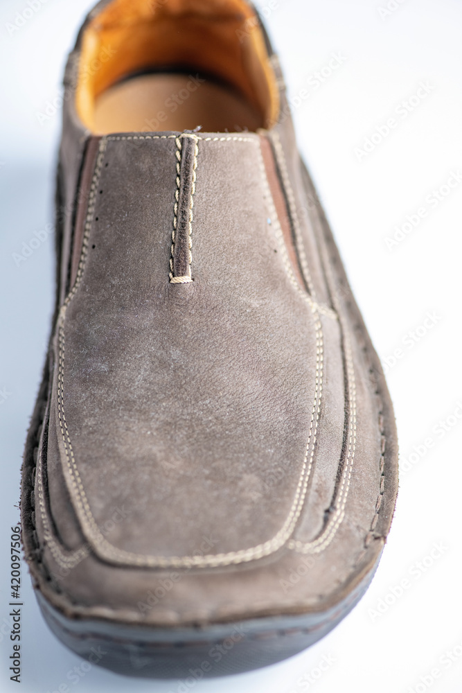 Wall mural men's leather loafers of brown color close-up on a light background.