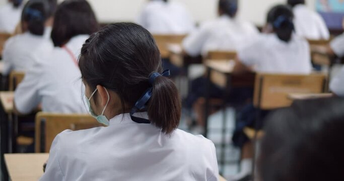 Asian high school students in white school uniform are serious and tired of exams.