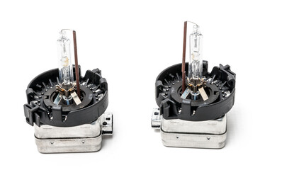 Xenon is a new lamp for automotive headlights on a white background. Gas-discharge lighting devices Xenon is a new lamp for automotive headlights. Used auto parts catalog from junkyard.