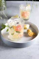 Glass of cool lemonade citrus summer fresh drink with orange, kumquat, lemon and tangerine 