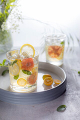 Glass of cool lemonade citrus summer fresh drink with orange, kumquat, lemon and tangerine 