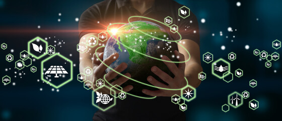 Man holding planet Earth as a green, ecological and renewable energy world concept. Elements of...