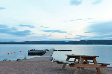 Picnic table and wooden dock on the lake in Sweeden.