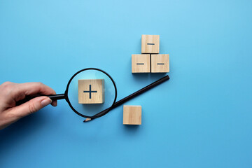 Wooden cubes in the form of a libra on one side plus on the other cons. Finding the pros in any...