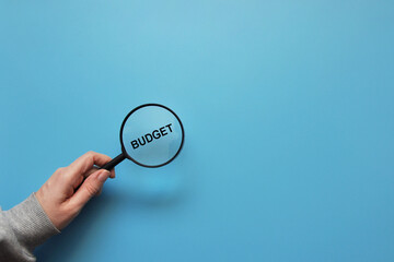 A man with a magnifying glass and the word 