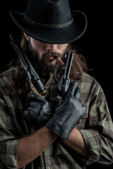 Fototapeta premium Cowboy with guns. Studio shooting
