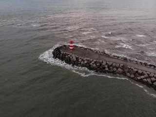 Foto auf Acrylglas Aerial panorama view of breakwater wavebreaker dam with red lighthouse at Scheveningen beach The Hague Netherlands © Marc