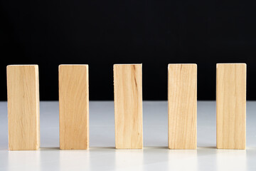 Business relationship concept arranging small wooden block on white background.Domino effect.