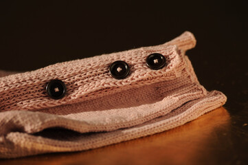 Knitted pink handmade sweater on a dark background