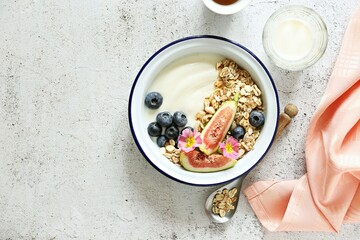 Muesli cereal mix with yogurt, fig and blueberries. Top view, copy space
