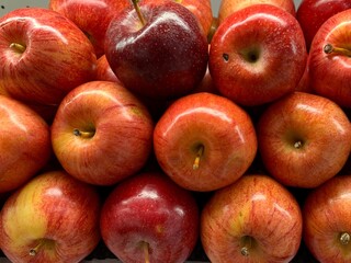 Piles of red apples. neatly arranged on the supermarket display rack. Fresh Organic Food. Background from Apple