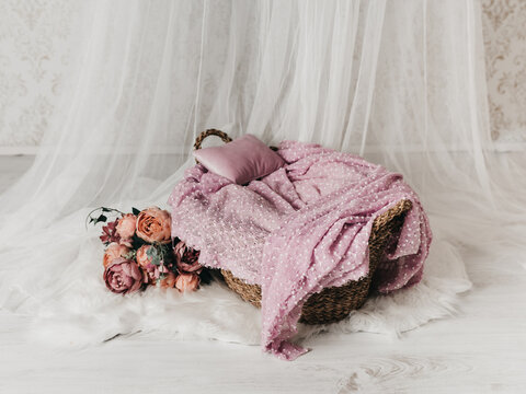 A basket for a newborn baby with dusty pink roses and a name of a baby