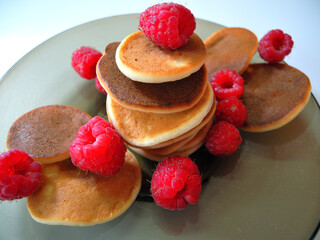 Small pancakes with fresh fruits and berries