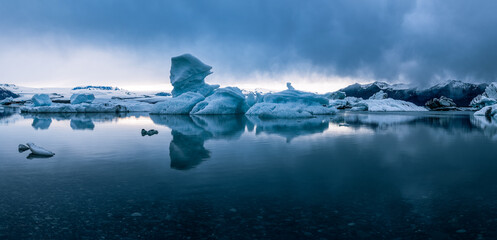 Panoramic view of icebergs in Jokulsarlon glacial lagoon while a snow storm is approaching the area...