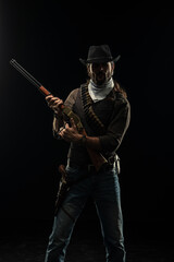 Fototapeta premium Cowboy with guns. Studio shooting