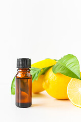 Lemon oil in a brown bottle. Alternative treatment with citrus, aromatherapy.