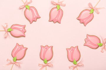 Gingerbread cookies in the shape of a tulip flowers on a pink background