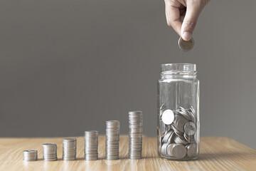 Financial businessman with coins put in a jar, Saving money for future growth and knowing how to...