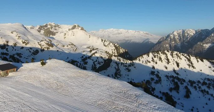 Chamrousse ski resort summit with shelter cabin at the French Alps, Aerial dolly in shot