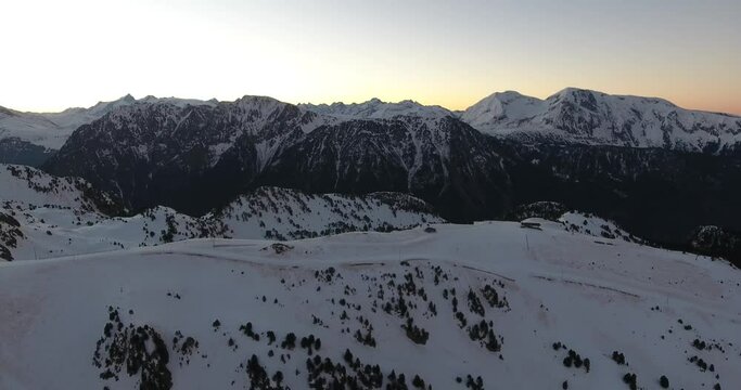 Chamrousse French alps during sunrise above the main ski tracks, Aerial flyover shot