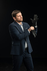 Young stylish man. Studio photo on a black background.