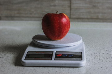 red apple on scale