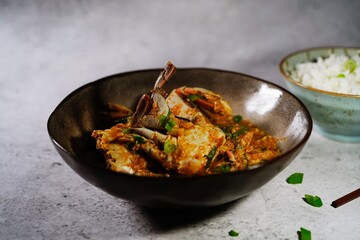 Homemade Singapore chilli crab served with jasmine rice, selective focus