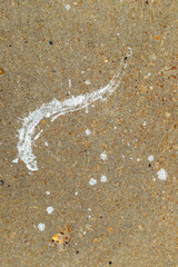 A sidewalk with paint splatters