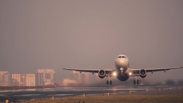 Airplane (aircraft) takes-off (taking off) at sunset