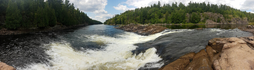 Panoramic picture of the Recollet Falls of the French River near Hwy. 69 and the ongoing French River surrounded by a mixed forest
