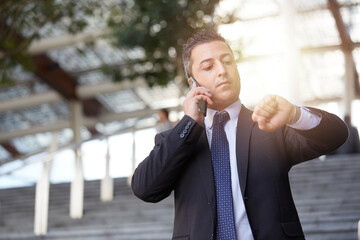 businessman talking to mobile in urban environment