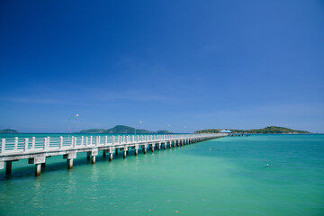 Fototapeta na wymiar Concrete walk bridge across the sea with the blue sky at rawai beach, phuket Thailand