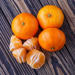 Mandarine orange or tangerine on wooden board