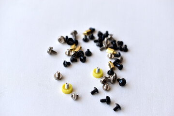 Various bolts and nuts from appliances on a white background