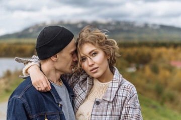 young couple in love in the park. a romantic walk in the open air. relationships between men and...