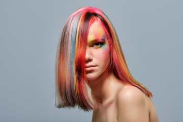 Beauty portrait, young model with colored hair and creative make-up