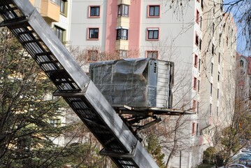 House removal with hydraulic ladder truck. Moving lift carrying furniture up in a residential...
